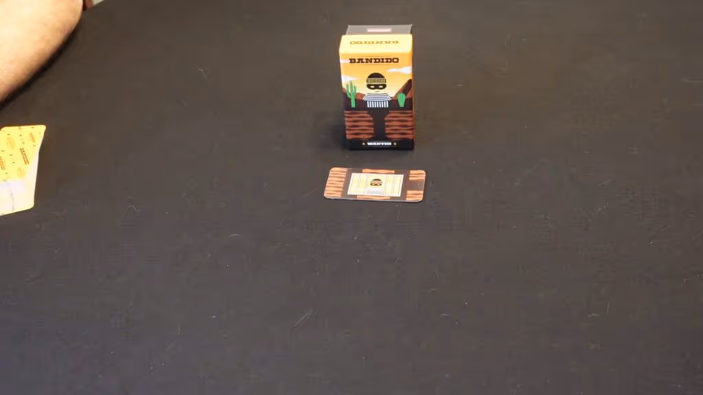 Bandido game box and card on dark surface