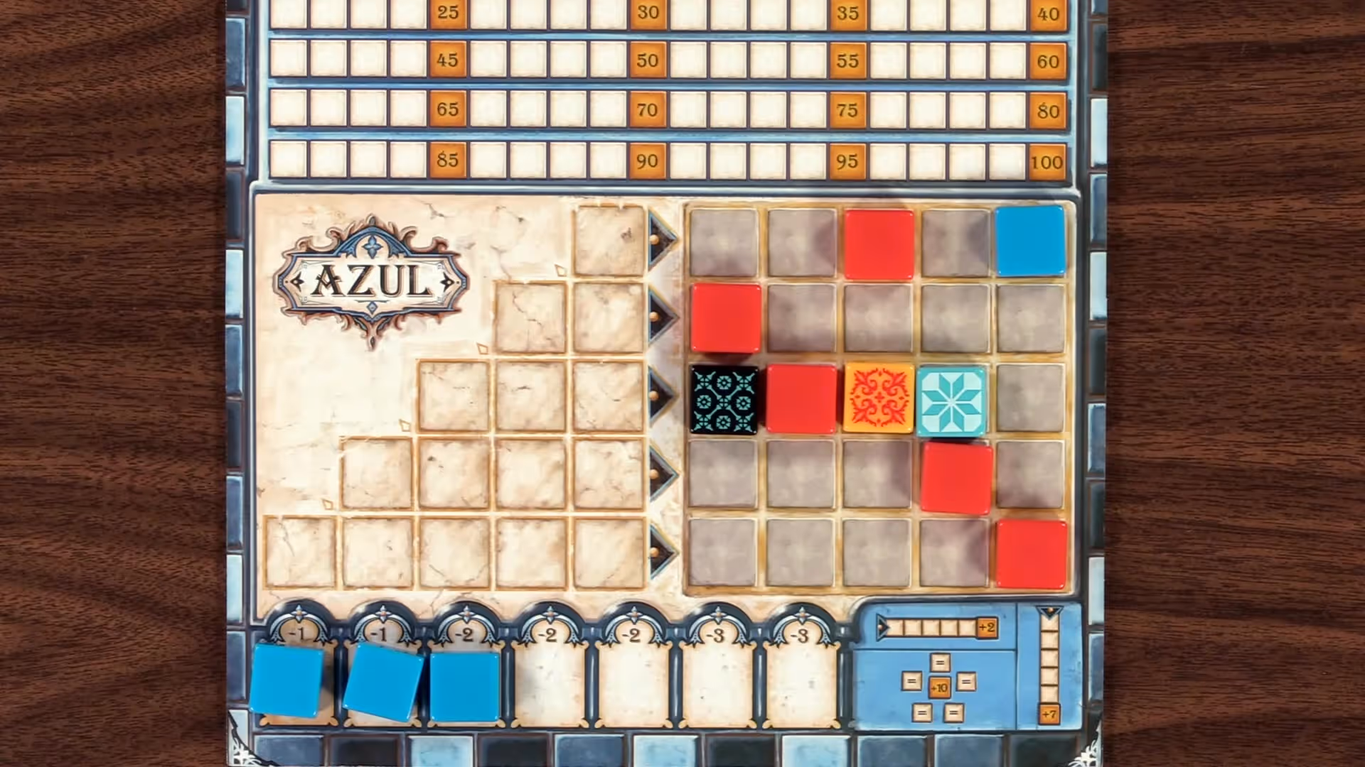 Player placing a red tile on their Azul board.
