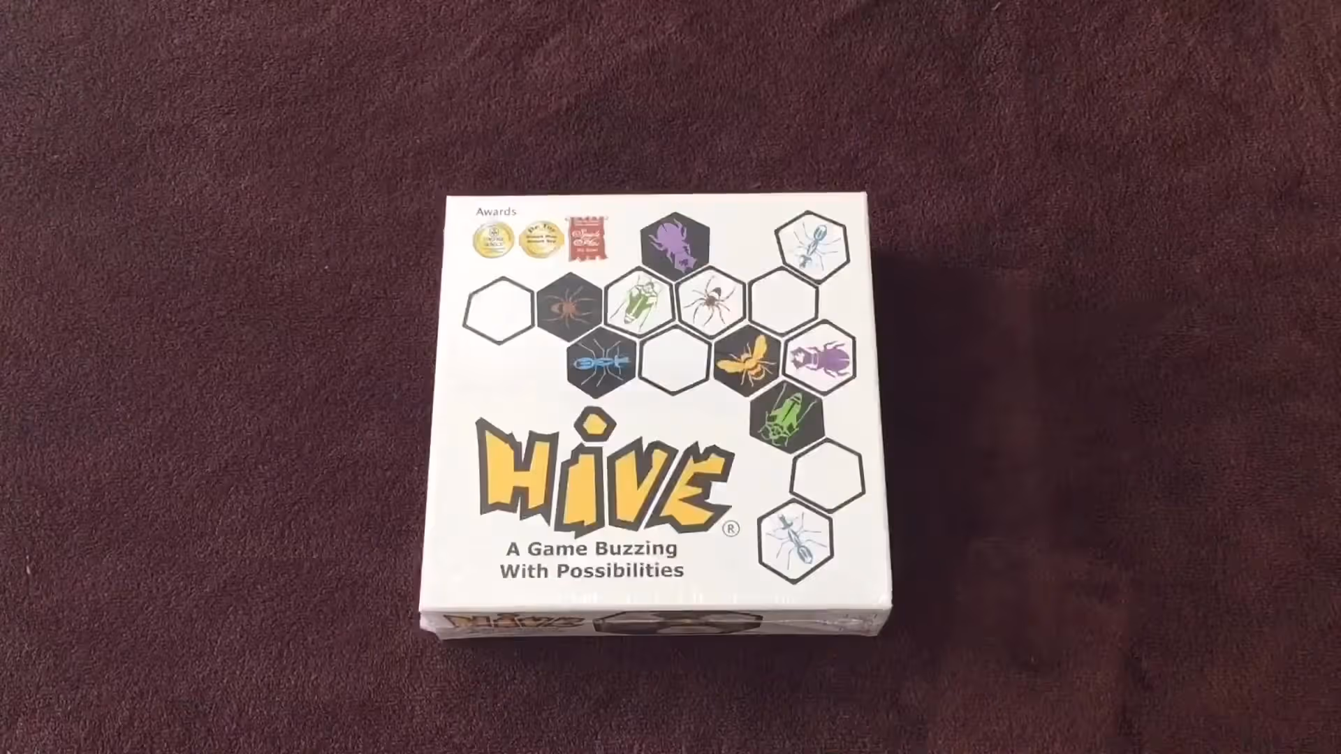 Hive game box on a brown surface