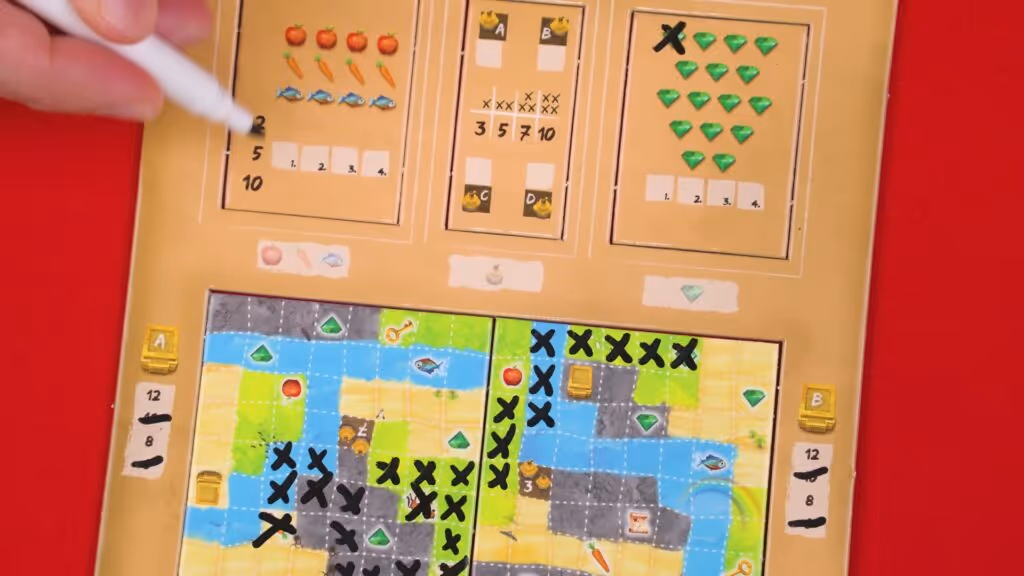 Hand marking a Ravensburger's Explorers game board with various icons and tokens.