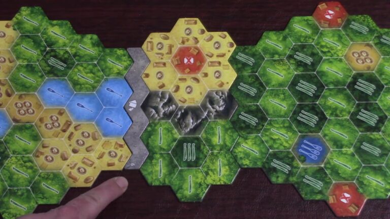 Hand pointing at The Quest for El Dorado game board with hexagonal terrain tiles and tokens.
