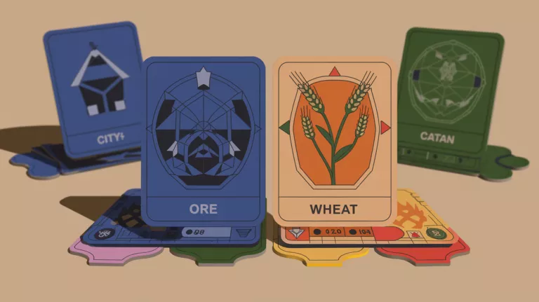 Close-up of Catan ore and wheat cards with a city card and other resources in the background.