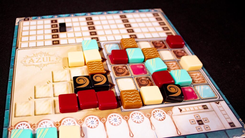Azul: Master Chocolatier player board with colored chocolate tiles.
