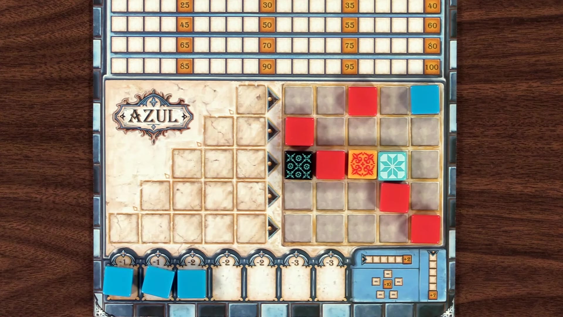 Player placing a red tile on their Azul board.