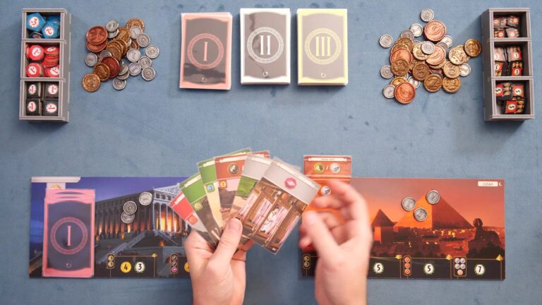 Players holding cards in a game of 7 Wonders with coins and age decks visible.