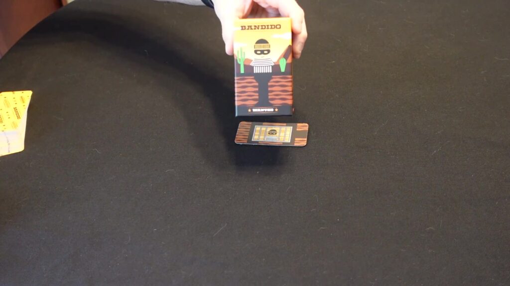 Bandido cooperative card game box and card, featuring a playful bandit character